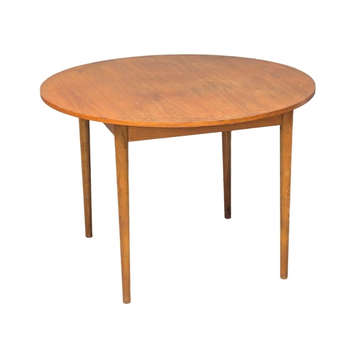 345 - A Mid Century teak dining table. 105x73cm. (2)