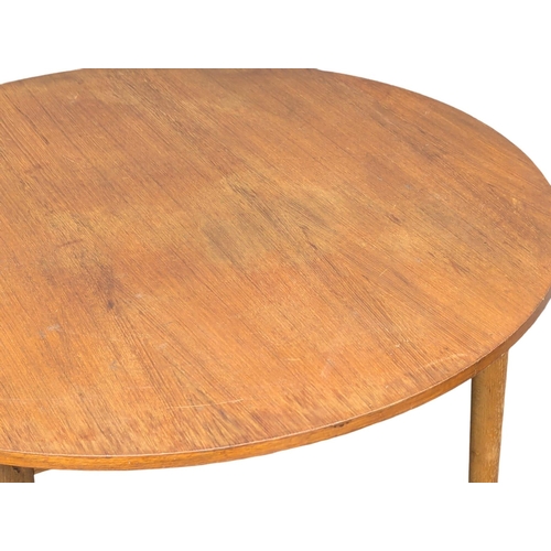 345 - A Mid Century teak dining table. 105x73cm. (2)