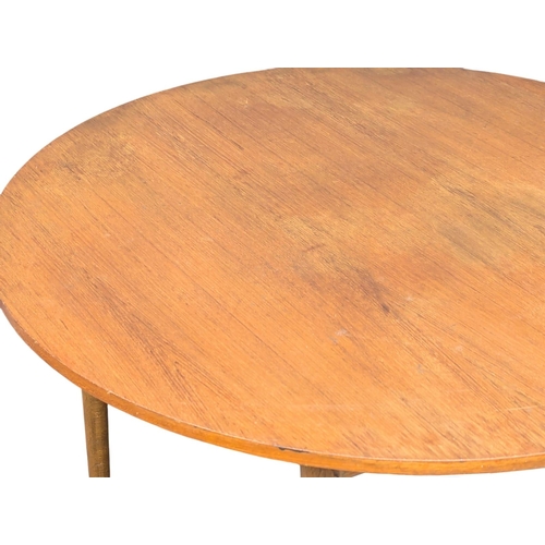 345 - A Mid Century teak dining table. 105x73cm. (2)