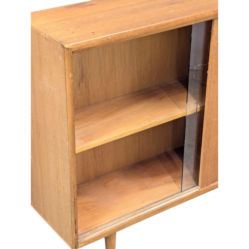 346 - Herbert Gibbs. A Mid Century teak bookcase by Herbert Gibbs. 107x25x76cm. (2)