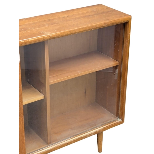 346 - Herbert Gibbs. A Mid Century teak bookcase by Herbert Gibbs. 107x25x76cm