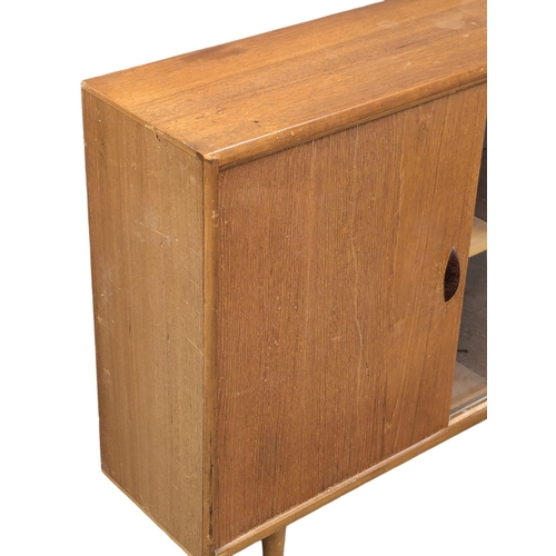 346 - Herbert Gibbs. A Mid Century teak bookcase by Herbert Gibbs. 107x25x76cm. (2)