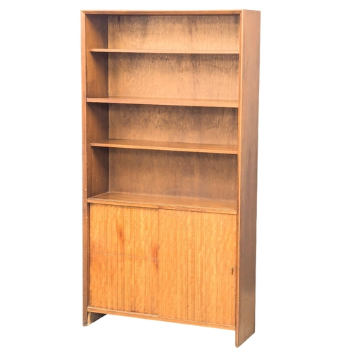 355 - Herbert Gibbs. A Mid Century tola wood open bookcase by Herbert Gibbs. 91.5x28x173cm