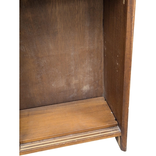 355 - Herbert Gibbs. A Mid Century tola wood open bookcase by Herbert Gibbs. 91.5x28x173cm