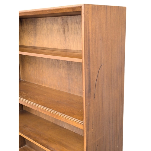 355 - Herbert Gibbs. A Mid Century tola wood open bookcase by Herbert Gibbs. 91.5x28x173cm