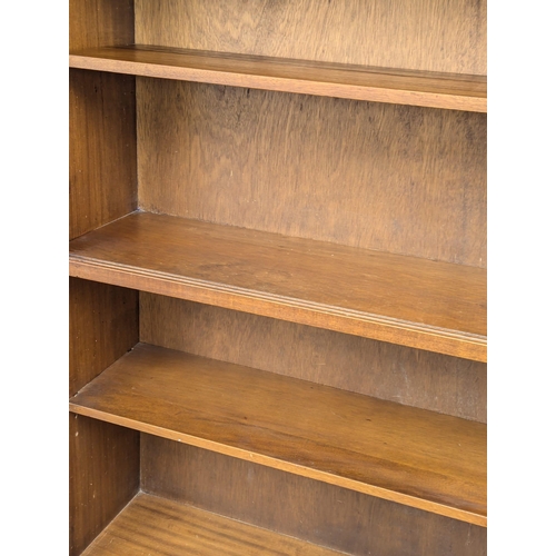 355 - Herbert Gibbs. A Mid Century tola wood open bookcase by Herbert Gibbs. 91.5x28x173cm