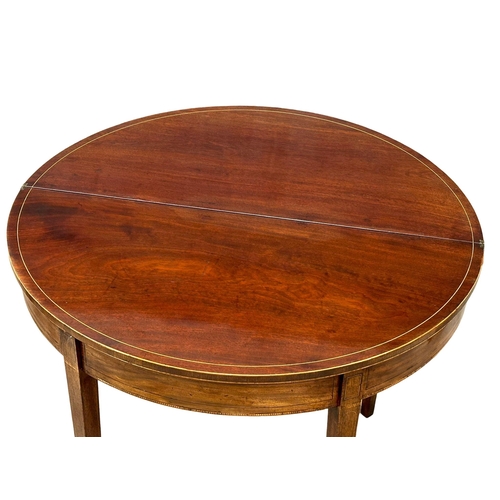 366 - A George III, Early 19th Century inlaid mahogany turnover tea table. In the Sheraton style. Circa 18... 