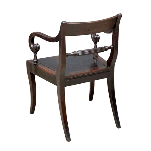 370 - A Regency Period, Early 19th Century mahogany armchair with scrolled arms and sabre legs. Circa 1810... 