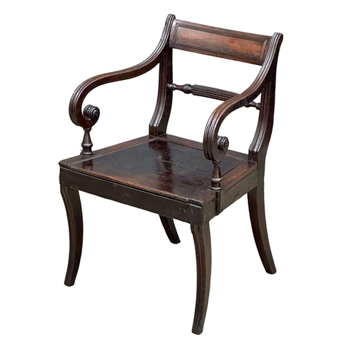 370 - A Regency Period, Early 19th Century mahogany armchair with scrolled arms and sabre legs. Circa 1810... 