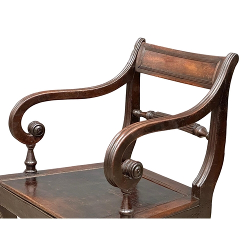 370 - A Regency Period, Early 19th Century mahogany armchair with scrolled arms and sabre legs. Circa 1810... 