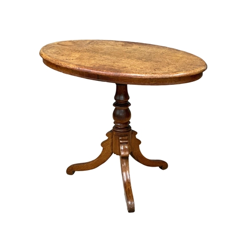 383 - A 19th Century Victorian oak tilt top table. 88x54x72.5cm. (9)