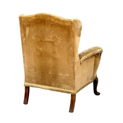 407 - An Early 20th Century Century Queen Anne style wingback armchair. Circa 1920.