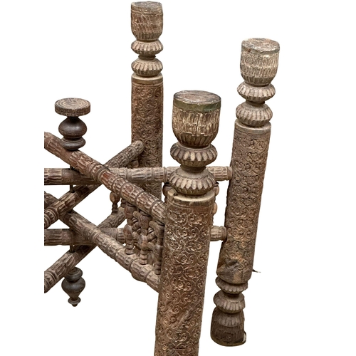 424 - A Late 19th Century Burmese carved teak folding table with brass tray top. 62x51cm