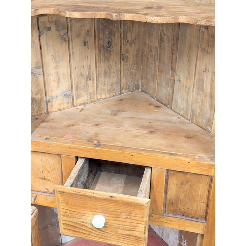 472 - A large Early 19th Century George III pine corner cabinet. 106x193cm