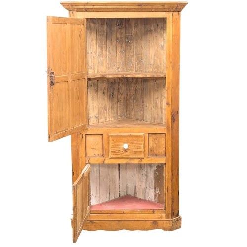 472 - A large Early 19th Century George III pine corner cabinet. 106x193cm