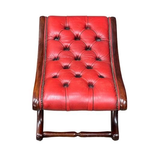 517 - A deep button leather footstool.