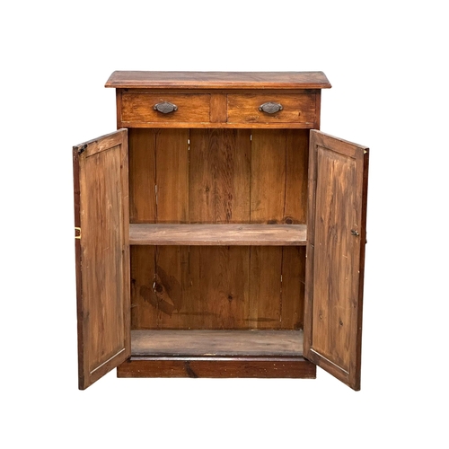 524B - A Late 19th Century stained pine, 2 door cupboard with fitted shelf and 2 drawers. Circa 1890-1900. ... 