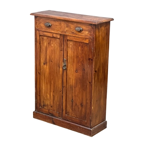 524B - A Late 19th Century stained pine, 2 door cupboard with fitted shelf and 2 drawers. Circa 1890-1900. ... 