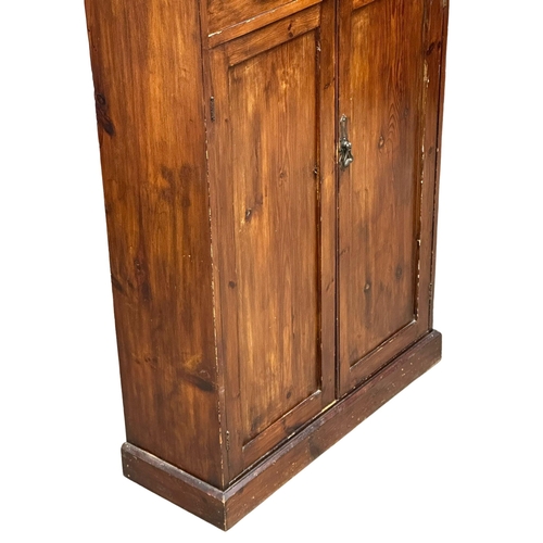 524B - A Late 19th Century stained pine, 2 door cupboard with fitted shelf and 2 drawers. Circa 1890-1900. ... 