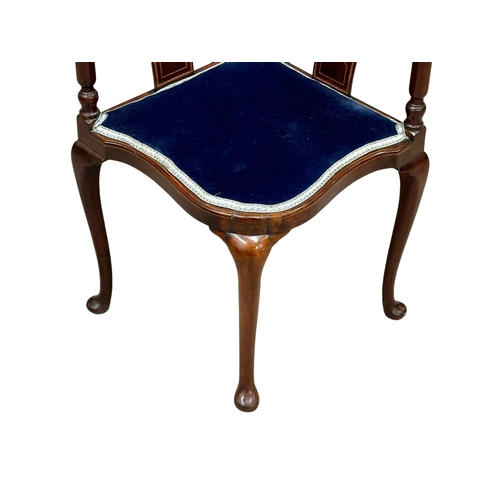 535 - An Edwardian inlaid mahogany corner armchair.