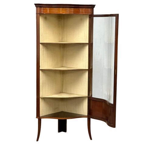 557 - An Edwardian inlaid mahogany corner cabinet with bowed glass and splayed feet. Sheraton Revival. 73x... 