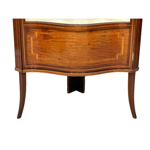 557 - An Edwardian inlaid mahogany corner cabinet with bowed glass and splayed feet. Sheraton Revival. 73x... 