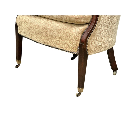 560B - A Mid 19th Century mahogany country house armchair on brass cup casters. 76x72x100cm