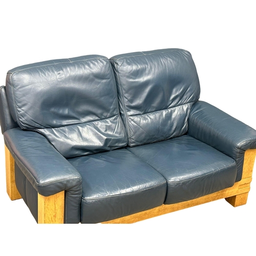 585 - A Norwegian style oak framed and leather 2 seater sofa. Ekornes style. 155cm