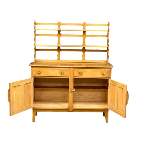 60 - An Ercol Mid Century elm and beech Windsor sideboard, with back plate rack. 131x50x156cm. (2)