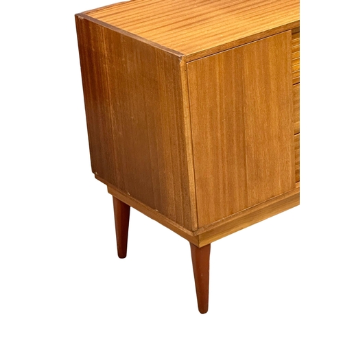 73 - Frank Guille for Austinsuite. A 1960’s Mid Century teak compact sideboard, designed by Frank Guille ... 