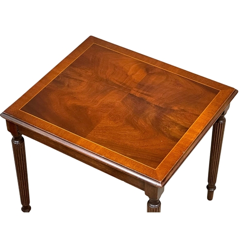 805 - A pair of Regency style inlaid mahogany lamp tables/side tables, on reeded legs. 47x40x41cm.