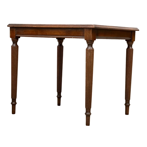 805 - A pair of Regency style inlaid mahogany lamp tables/side tables, on reeded legs. 47x40x41cm.