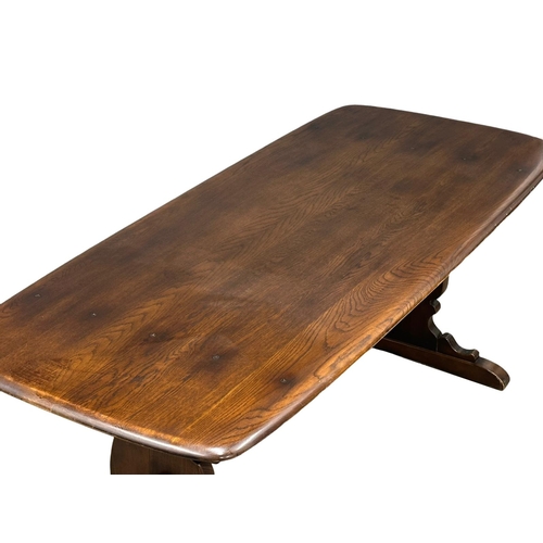 880 - An Ercol Mid Century elm and beech dining table. 183x81x73cm