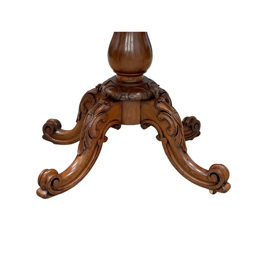 884A - A large 19th Century Victorian mahogany turnover tea table, with carved pedestal base. 99x49.5x75cm.