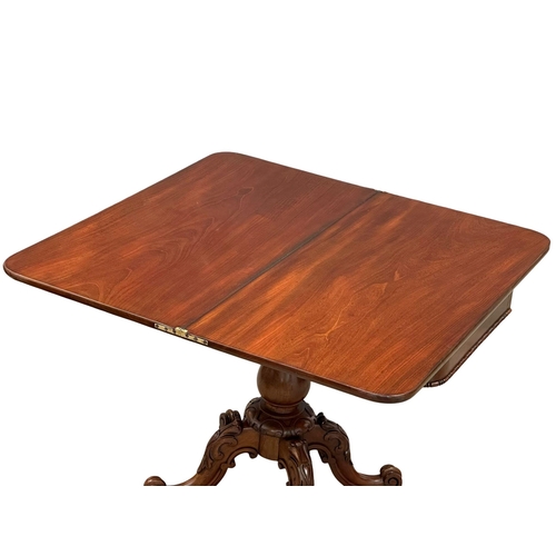 884A - A large 19th Century Victorian mahogany turnover tea table, with carved pedestal base. 99x49.5x75cm.