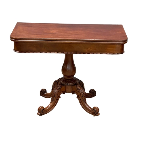 884A - A large 19th Century Victorian mahogany turnover tea table, with carved pedestal base. 99x49.5x75cm.