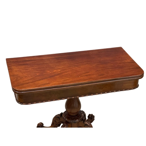 884A - A large 19th Century Victorian mahogany turnover tea table, with carved pedestal base. 99x49.5x75cm.