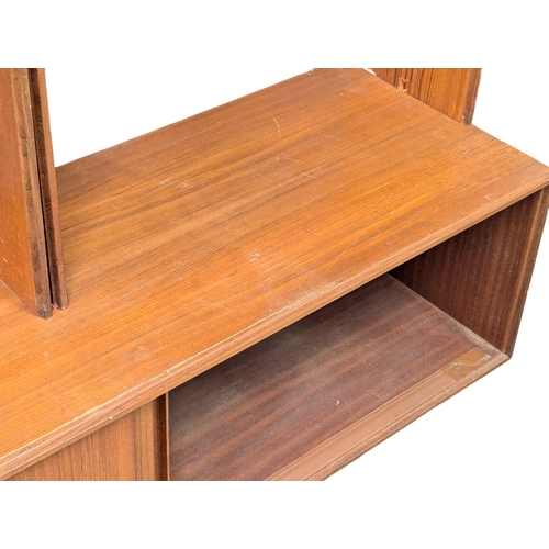 985 - A G-Plan Mid Century teak shelving unit with sliding doors. 152.5x46x199cm