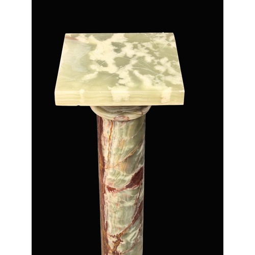 871A - An onyx stone torchiere stand. 101cm