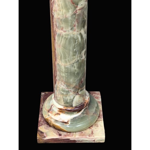 871A - An onyx stone torchiere stand. 101cm