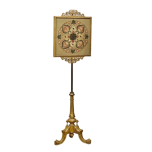 175 - A 19th Century Victorian gilt polescreen with embroidered panel on a brass column. 153cm. 7