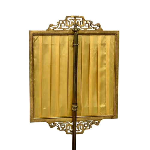 175 - A 19th Century Victorian gilt polescreen with embroidered panel on a brass column. 153cm. 7