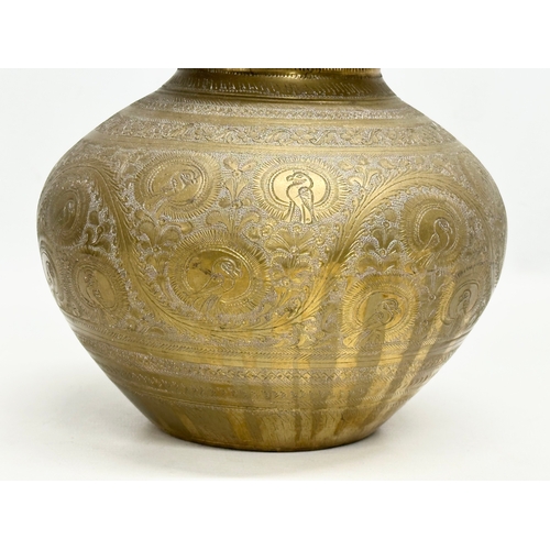 288 - A Late 19th Century Indian engraved brass jar with cover. 18x22cm.