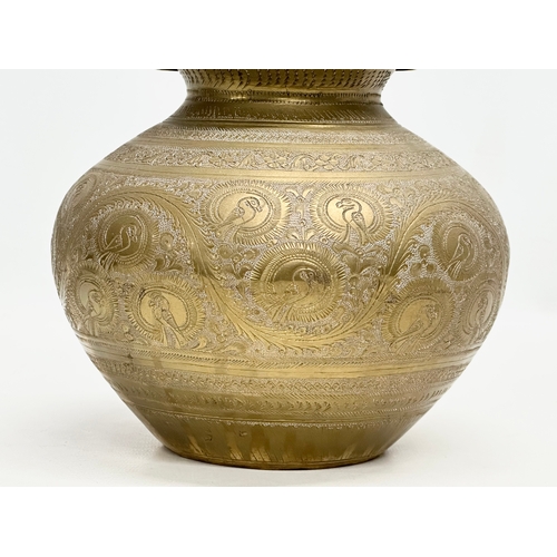 288 - A Late 19th Century Indian engraved brass jar with cover. 18x22cm.