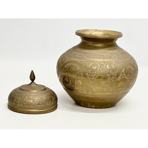 288 - A Late 19th Century Indian engraved brass jar with cover. 18x22cm.