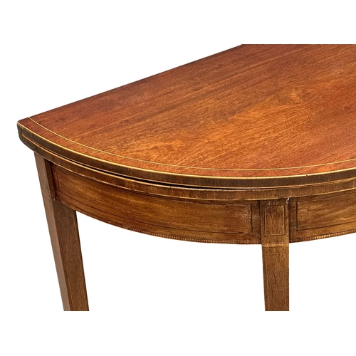 366 - A George III, Early 19th Century inlaid mahogany turnover tea table. In the Sheraton style. Circa 18... 