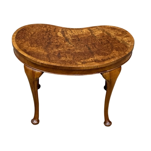 1009 - A Mid 20th Century burr walnut kidney shaped occasional table. 61x39x40cm. (9)