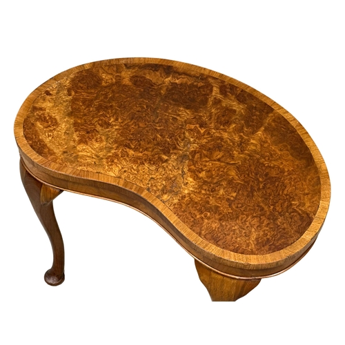 1009 - A Mid 20th Century burr walnut kidney shaped occasional table. 61x39x40cm. (9)