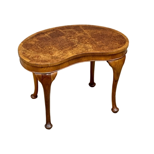 1009 - A Mid 20th Century burr walnut kidney shaped occasional table. 61x39x40cm. (9)