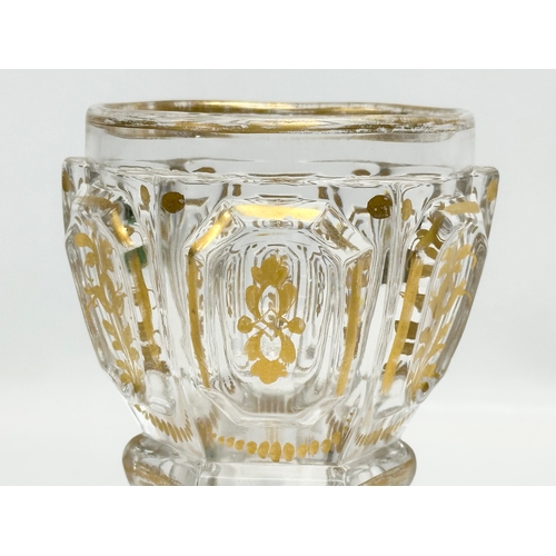 26 - Baccarat. A 19th Century French gilt “Harcourt Empire” glass cup. 10x9.5x16cm.